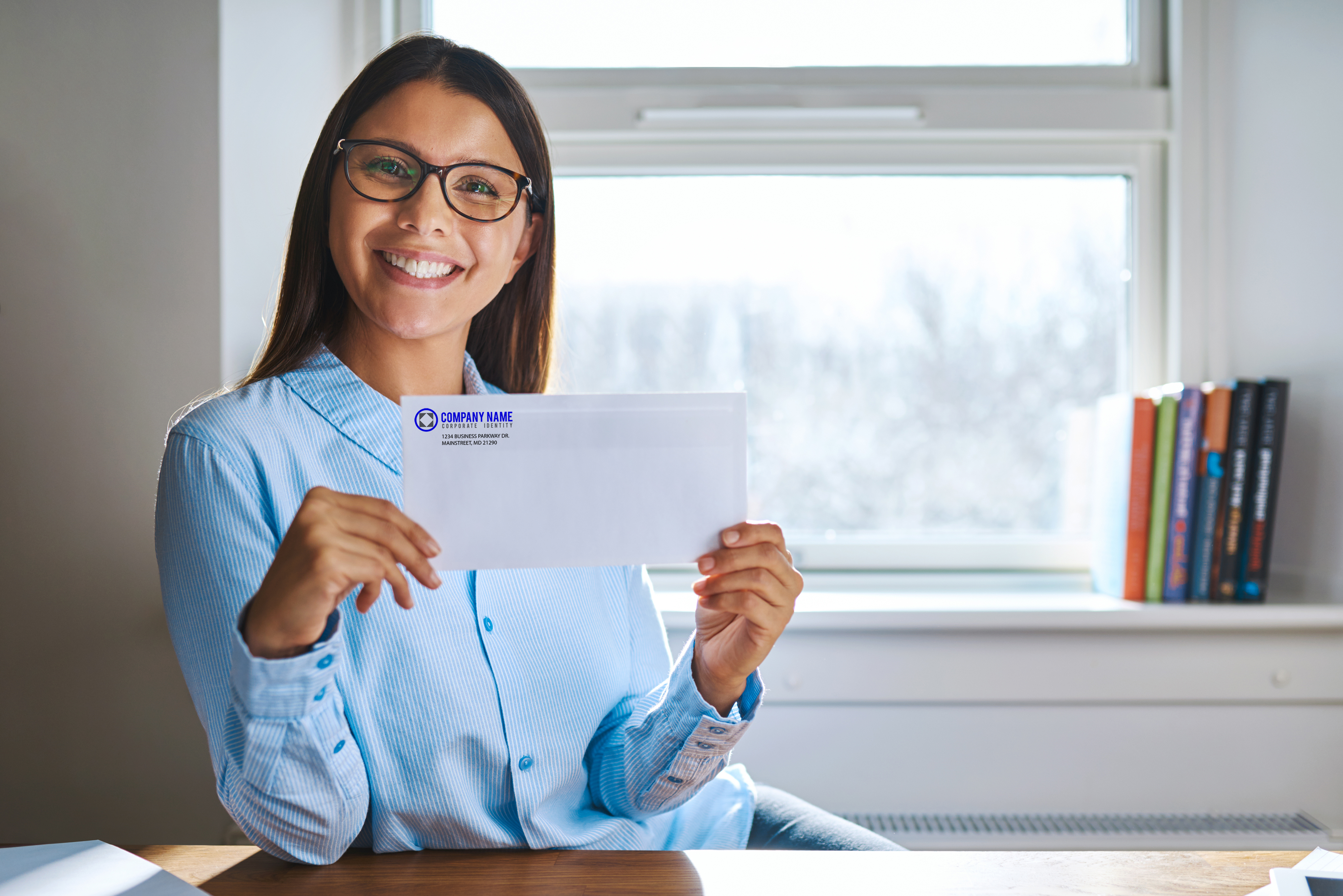 Woman holding up a custom corporate envelope
